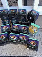 Photo of 16 boxes of Morph stress relief balls arranged on the ground, with one ball partially out of its box but still plastic wrapped.