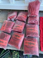 Seventeen individually wrapped red CYBORG bar mat towels shown in their original packaging.