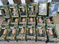 All 18 Titans vinyl figures boxed, arranged in rows, clearly showing packaging and figure heads