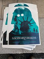 Stack of green-themed Space Balls movie poster prints showing the front design with a silhouette and Statue of Liberty motif