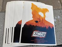 Stack of 25 identical movie prints titled 'The Schwartz Awakens' from Space Balls showing artwork with orange silhouette and forest castle scene.