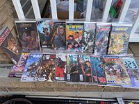 Photo showing assortment of 34 variant cover comic books, some bagged and boarded and some factory sealed, from various titles including Harbinger Renegade, Red Son, Super! and others.
