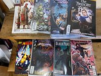 Photo showing various variant cover comic books including Hellboy #195, Pacific Rim, The Twilight Zone, Judge Dredd, Batman, Black Panther, and Vampire titles with plastic protective sleeves