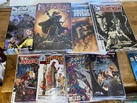 Photo shows stacks of sealed comic books with variant covers from series including Star Trek, Red Sonja, Sovereign, Hellboy, Silver Surfer, and The Orphan.