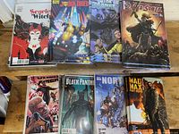 Photo showing 8 different variant exclusive comics: Scarlet Witch, Joe Dredd, Star Trek, Red Sonja, Valkyrie, Black Panther, North, and Mad Max: Fury Road, 5 copies each.