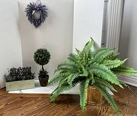 Lot arrangement showing artificial fern in brass planter, lavender plant, heart-shaped lavender hanging decor, faux succulents, catnip in cement planter, and boxwood topiary.