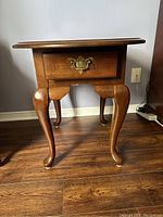 Front view of the Broyhill solid wood occasional end table showing single drawer and cabriole legs