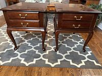 Front view of pair showing two drawers and cabriole legs