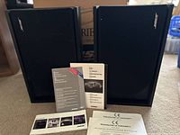 Two speakers side by side with paperwork in front