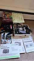 Overview photo showing Canon PowerShot G5 box, camera, user manuals, and a small box containing cords and accessories