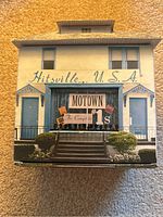 Box designed like Hitsville U.S.A. house with Motown The Complete No. 1s label on front.