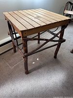 Side angle of rustic hickory and oak side table showing slatted oak top and twig-like hickory base