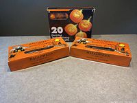 Overview photo showing three boxed Halloween light strings: two 10-light sets in orange boxes and one 20-light set in black box with pumpkin images.