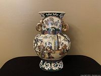 Front view of the antique Satsuma vase showing hand-painted geishas and gold details on a green background.
