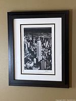 Full view of framed Empire State Building print hung on wall