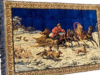 Close-up image of the Soviet hunting tapestry rug showing the detailed horse riders, wolves, and snowy landscape with ornate border.