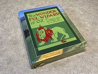 Front cover of The Wonderful Wizard of Oz book showing the illustrated lion on the dust jacket.