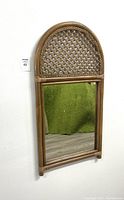 Full view of the bamboo wall mirror with arched woven top and rectangular mirror