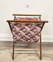 Front view of vintage folding knitting basket caddy showing quilted fabric side and hardwood frame.