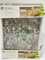 Photo of GE Glitter Gem Garland box showing the packaging with clear glitter gem lights inside and box damage.