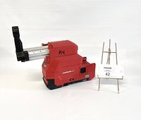 Side view of the Milwaukee Hammervac dust extractor showing the extendable metal arm and red housing with 'Hammervac' branding and 'RH' marking.