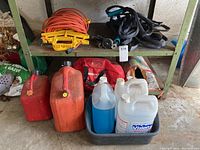 Overall image showing shelves with assorted automotive and outdoor items including jerry cans, emergency kit, hoses, and extension cord