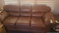 Full front view of the brown leather sofa