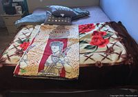 Woven throw, plush blanket, small throw, and four accent pillows displayed on bed