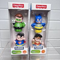 Front view of Green Lantern and Batman Fisher Price Little People figurines in original packaging, showing clear plastic window on white box with Fisher Price and DC Super Friends branding.