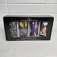 Front view of the glassware set in original box, showing four glasses with Nightmare Before Christmas characters.