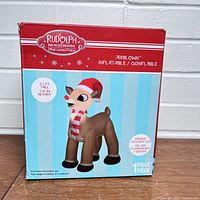 Box front showing Rudolph inflatable image, red and white stripped scarf, red nose blinks with energy-efficient LED, 3.5 ft tall