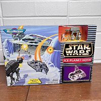 Front view of the sealed Star Wars Micro Machines Ice Planet Hoth playset box with artwork showing Imperial AT-AT walker battle scene on snowy terrain and inset window showing included figures and vehicle.