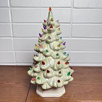 Front angle photo of the vintage ceramic Christmas tree showing multi-colored bulbs and iridescent finish.