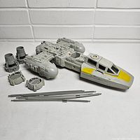 Y-Wing Fighter vehicle main body, engines, and metal rods arranged on white background showing all pieces included