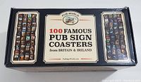 Box front showing '100 Famous Pub Sign Coasters from Britain & Ireland' with sample images of coasters on sides
