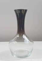 Side view of vintage mercury glass decanter showing flared neck and reflective mercury interior
