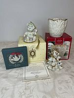 Three Lenox Christmas home decor items: two figurines and one ceramic vase with original boxes and certificate of authenticity.