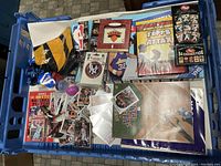 Top view of the entire contents showing a variety of sports cards, sports memorabilia, trading card binders, and boxed game.