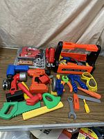 Toy plastic tools varied colors arranged on table