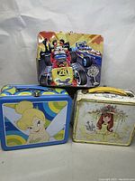 Front view of all three metal lunch boxes showing various vintage Disney and classic character designs