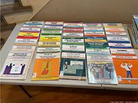 Overhead view of 32 business and professional development books from the 50 Minute series arranged in rows on a table with visible titles on covers.