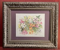 Framed watercolor painting titled 'Bermuda Island Flowers' showing detailed closeup of colorful tropical flowers in a gold decorative frame.