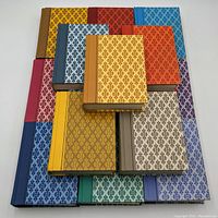 Top view showing the varied vibrant and patterned hardcover books arranged flat to display covers and colors.