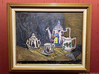 Frontal image of the oil painting showing the complete art of tea set still life in a wooden frame against a red wall.