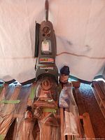 Full view of Bissell PowerForce carpet cleaner with attached power cord and included cleaning solutions and accessory items placed in front. Showcases overall condition and contents.