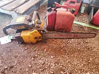 Side view of yellow Pioneer Partner chainsaw with attached 18" Oregon bar and red gas can beside it