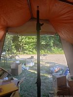 Full view of one black adjustable stand showing height mechanism and tripod base