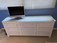 Front view of entire dresser against blue wall