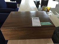 Closed view of rectangular wooden humidor with label showing dimensions 12.5x9x4.5 inches