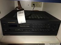 Front view of the Marantz SR-3600 stereo receiver showing power button, blue display screen, various tuning and input selection buttons including Dolby surround and bridgeable amplifier labels.